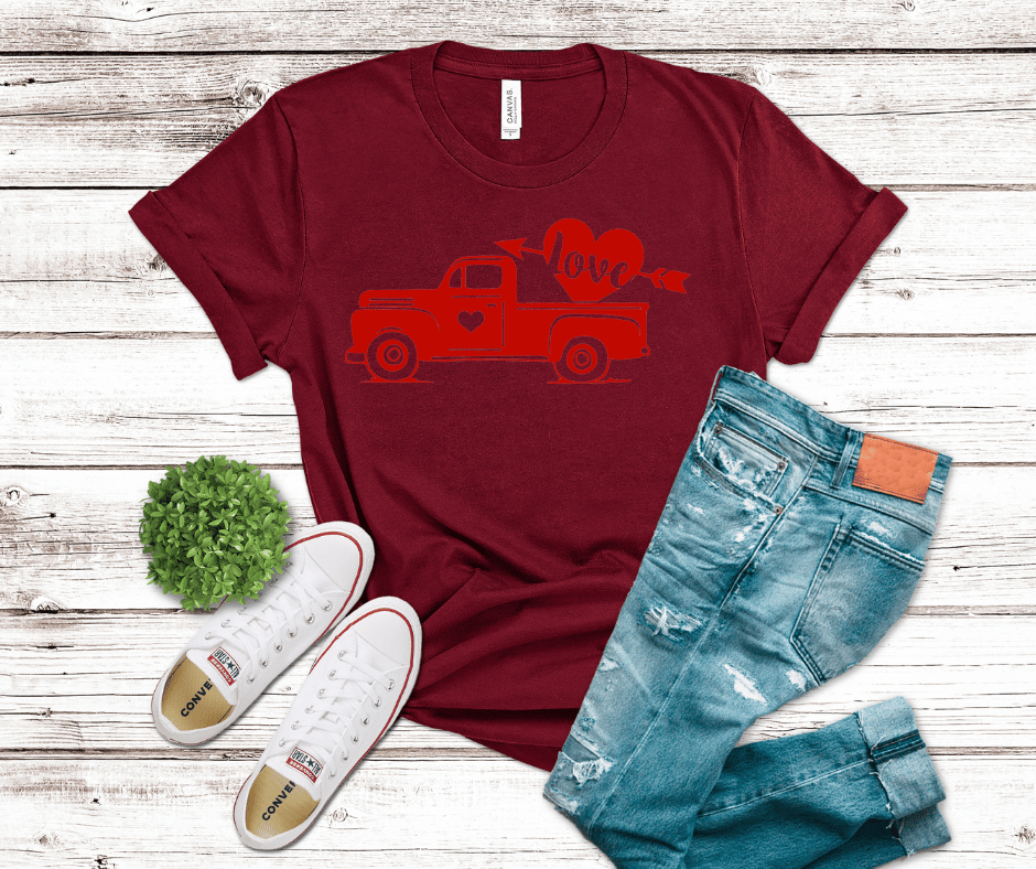 Red vintage pickup truck carrying a heart with an arrow and the word “love” printed as a Hot Peel DTF transfer.