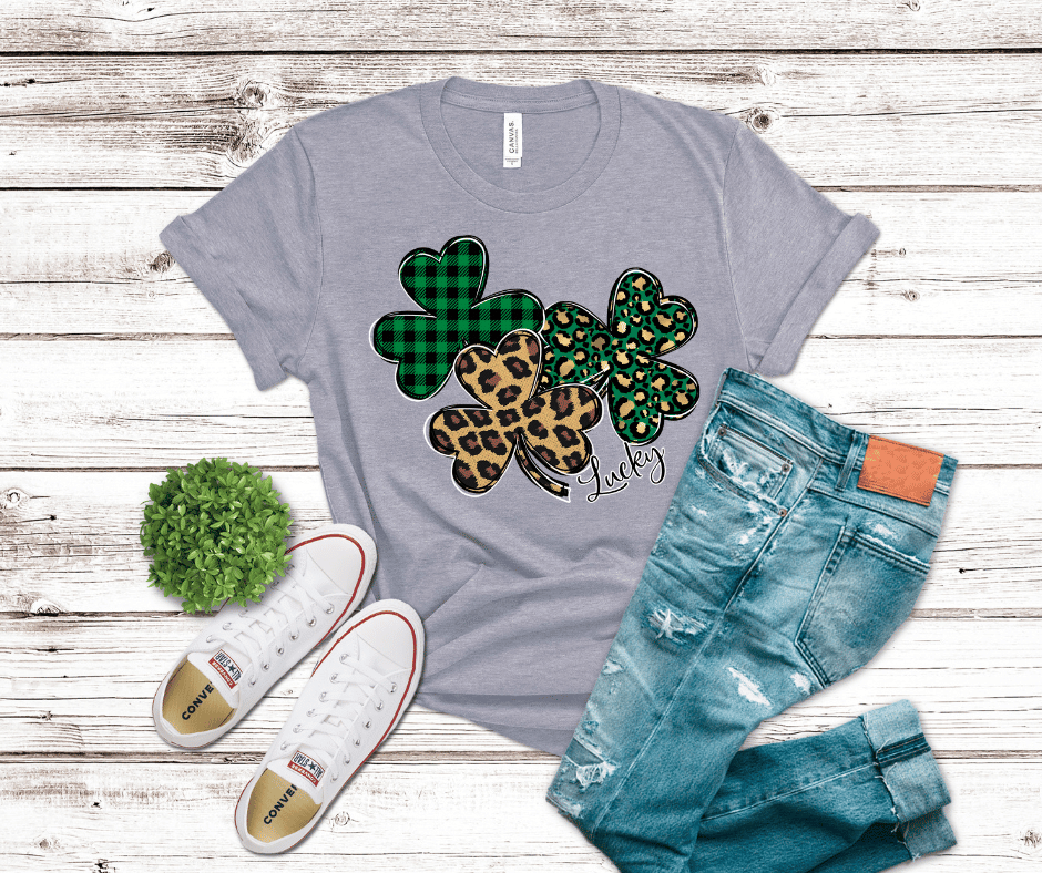 Lucky shamrock shirt with leopard print and green buffalo plaid clovers and “Lucky” script design.