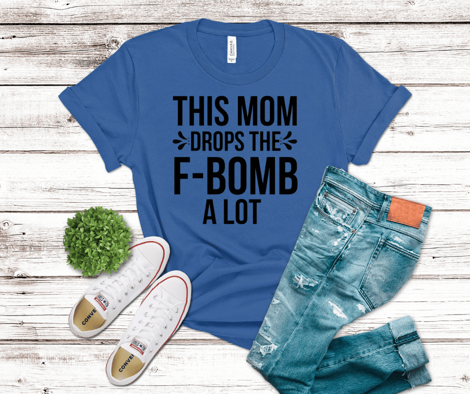 Black bold typography reading “This Mom Drops the F-Bomb a Lot” on a blue background, minimalist modern DTF transfer design for humorous mom apparel.