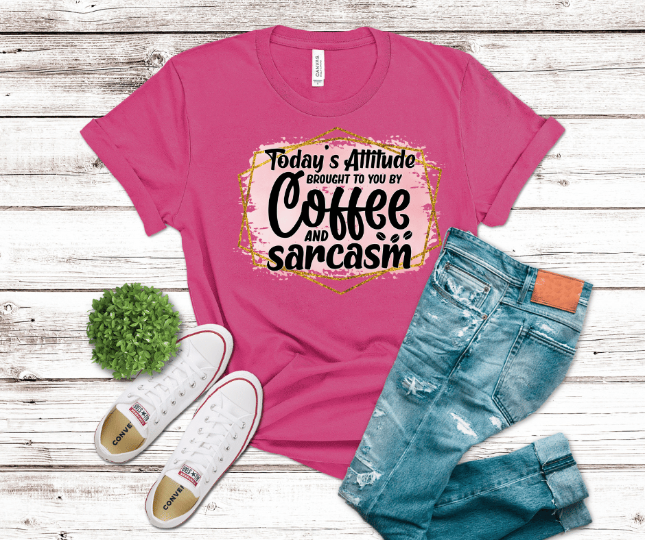 “Today’s Attitude Brought to You by Coffee and Sarcasm” text on pink distressed background with gold geometric frame — DTF transfer design.
