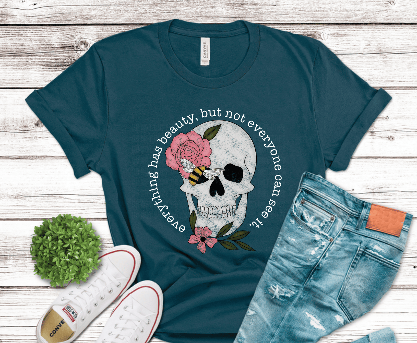 Detailed skull with pink flowers and bee accent for gothic floral shirt design