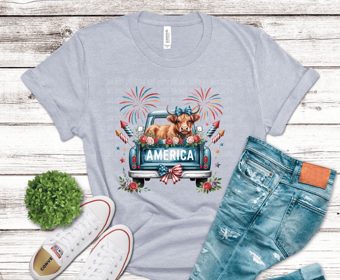 Cow sitting in a vintage pickup truck with American flags and flowers with America text.