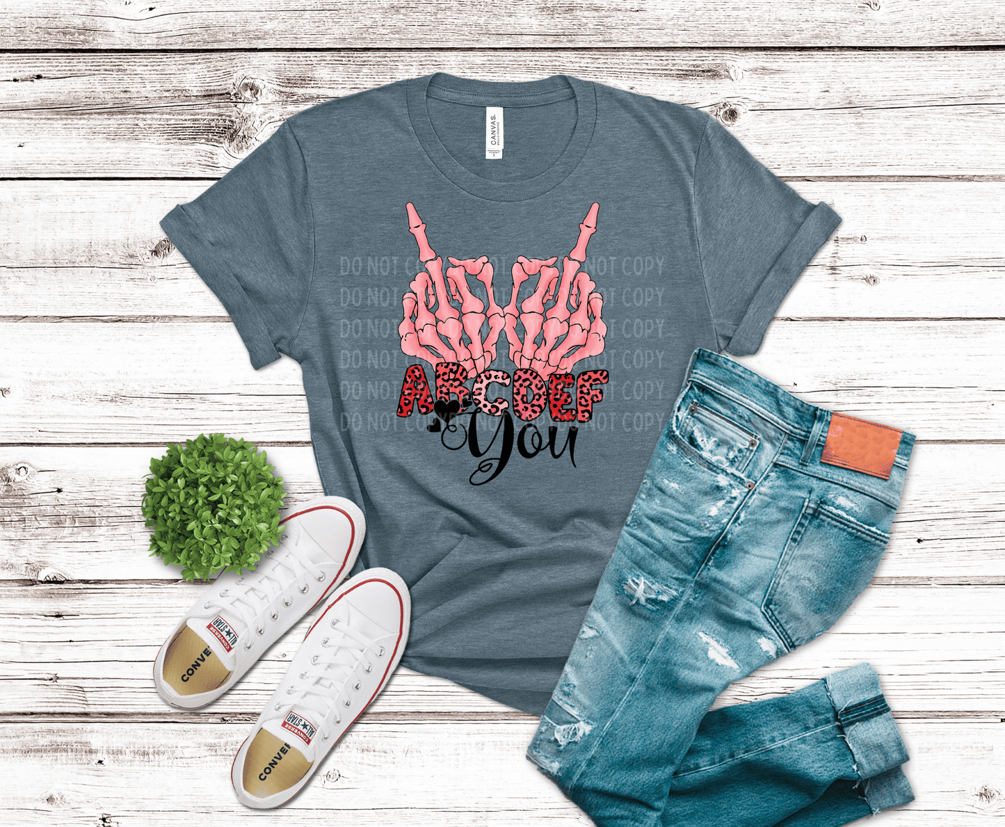Pink skeleton hands making a bold gesture above “ABCDE F You” text with leopard print lettering, edgy Valentine-themed DTF transfer design.