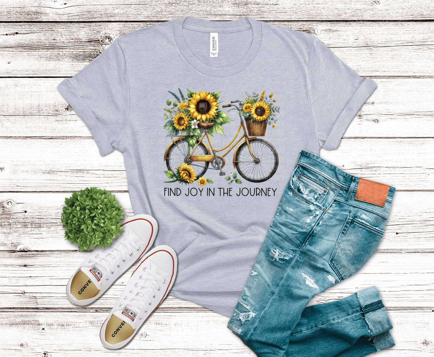 DTF transfer featuring a vintage bicycle decorated with bright sunflowers, leafy greenery, and a floral basket in warm yellow and green tones.