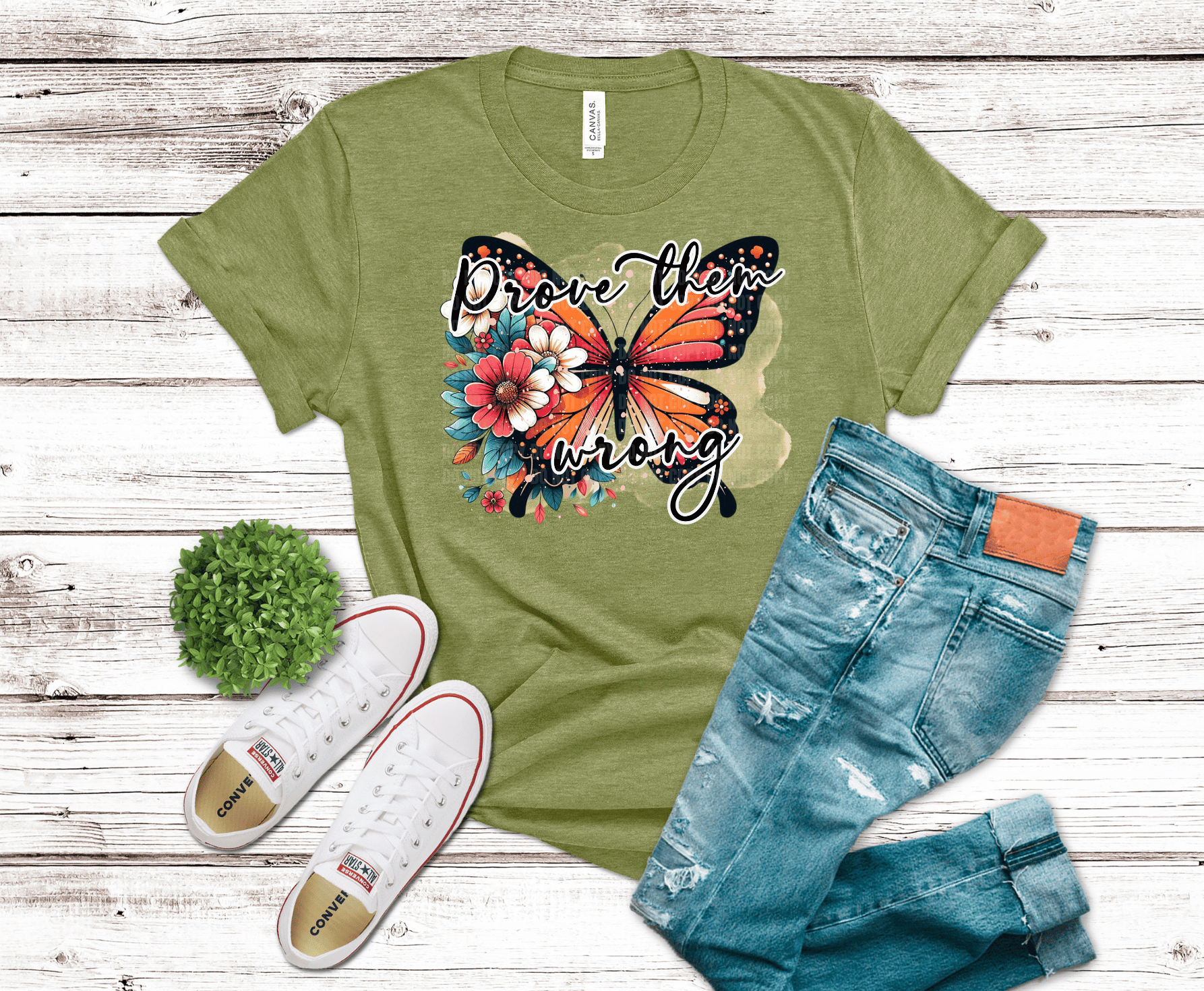 DTF transfer featuring a colorful butterfly with floral accents and the phrase “Prove Them Wrong” in bold script on a soft abstract background.