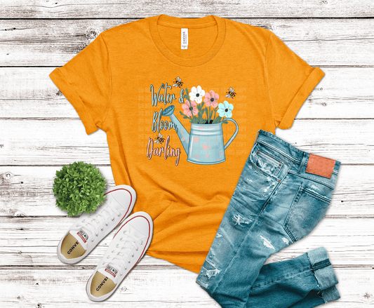 Watering can with flowers and bees with text Water & Bloom Darling.