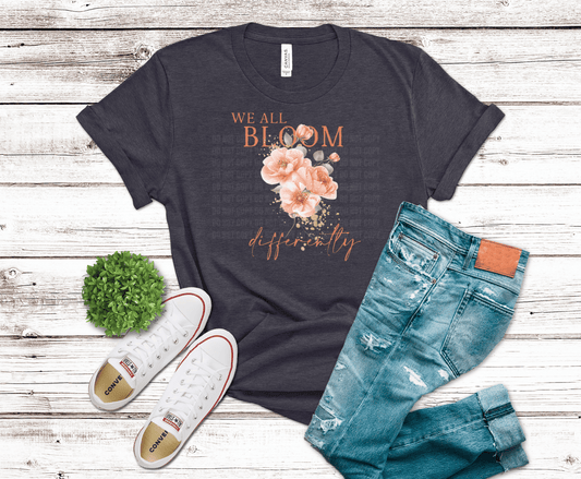 Soft floral design with text We All Bloom Differently.