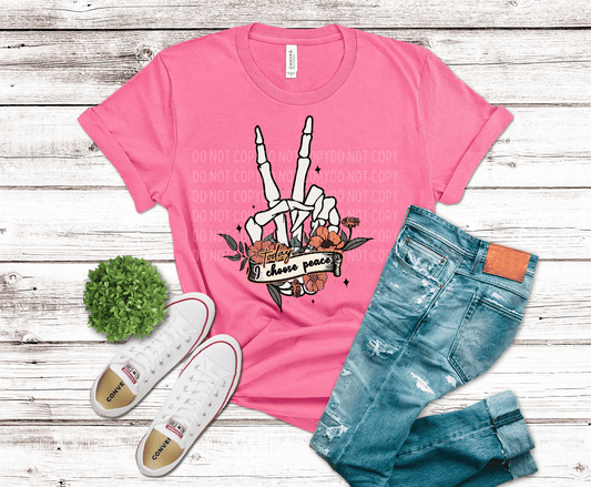 Skeleton hand making peace sign with floral elements and banner saying i choose peace edgy inspirational design