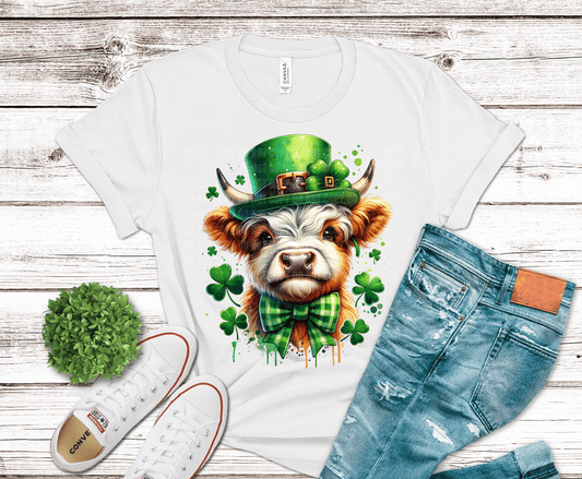 DTF transfer design of a Highland cow wearing a green leprechaun hat and plaid bowtie, surrounded by shamrocks in a festive St. Patrick’s Day style.