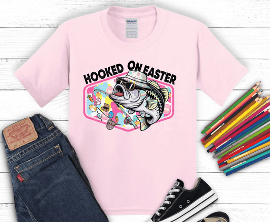 Cool largemouth bass wearing sunglasses and bucket hat holding fishing rod with pastel Easter egg background for funny fishing Easter shirts