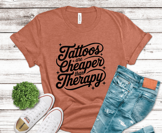 Bold script typography reading Tattoos Are Cheaper Than Therapy for tattoo lover shirts
