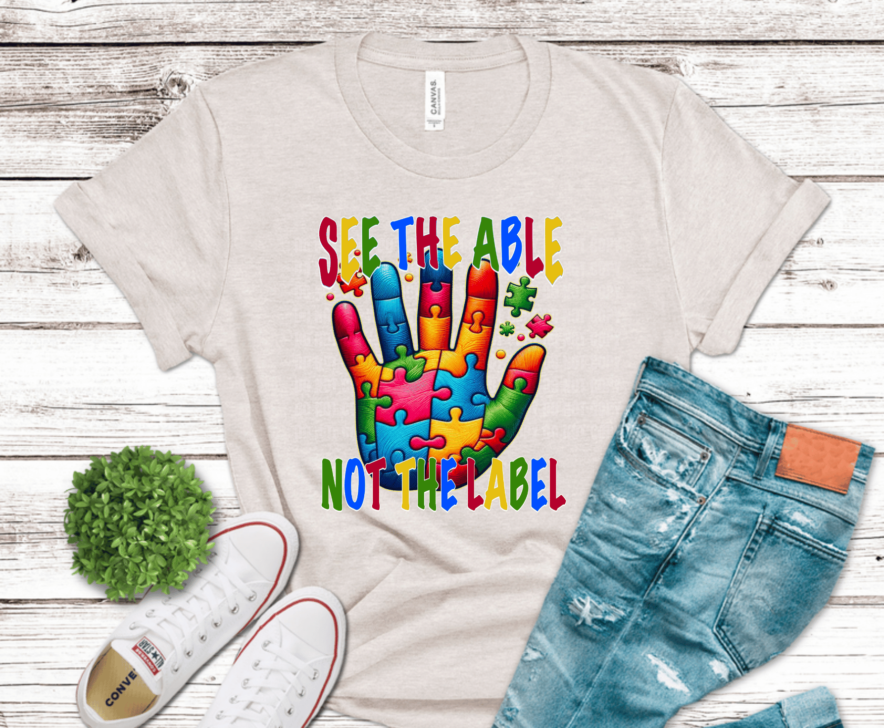 Colorful puzzle hand with See the Able Not the Label awareness message