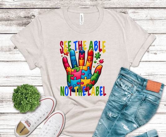 Colorful puzzle hand with See the Able Not the Label awareness message