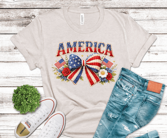 Vintage America patriotic bow floral design with American flags and red white blue flowers.