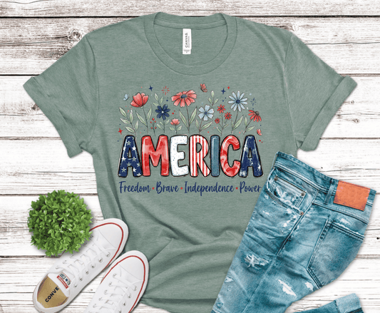 Patriotic America lettering design with red white blue colors and floral accents.