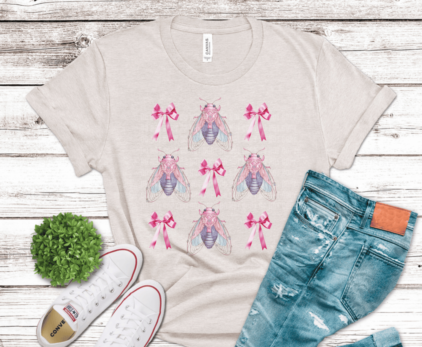 Pattern of insects with pink bows in a repeating design.
