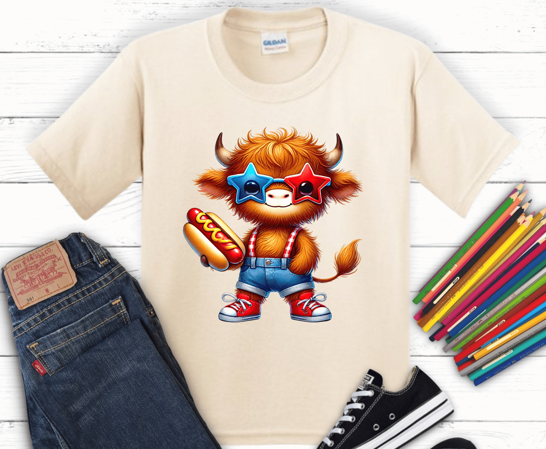 Highland cow wearing patriotic glasses holding hotdog.