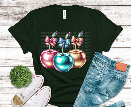 Three glossy cherries with decorative bows.