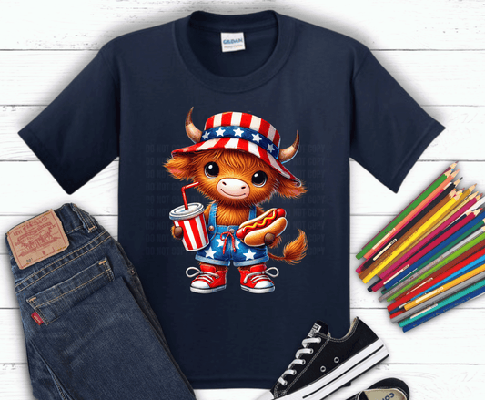 Highland cow wearing patriotic outfit holding hotdog and drink.