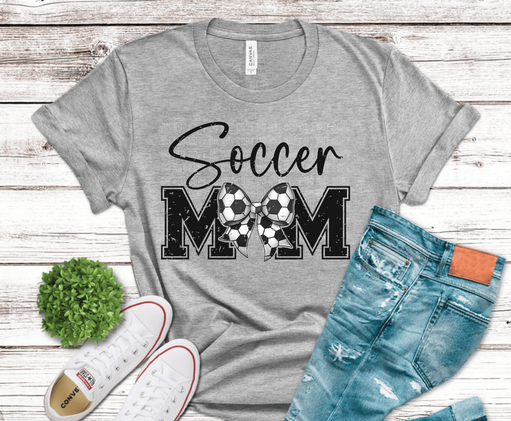 Cute soccer mom bow design made of soccer balls with bold distressed lettering for feminine sports mom apparel