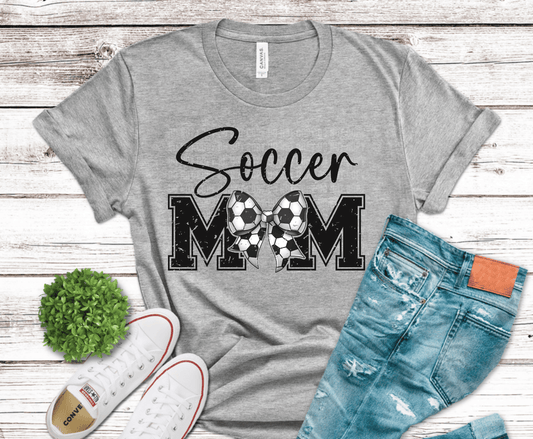 Cute soccer mom bow design made of soccer balls with bold distressed lettering for feminine sports mom apparel