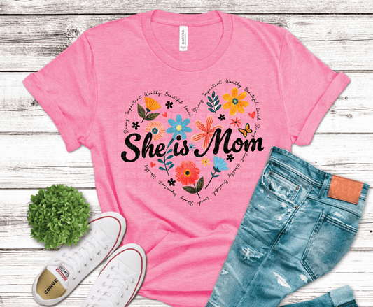 She is mom floral circle design with colorful flowers surrounding bold script motherhood text