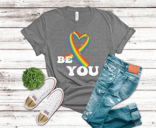 Rainbow awareness ribbon shaped like heart with vibrant colors representing pride equality and inclusion