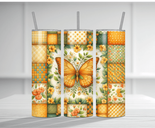 Vibrant 20oz tumbler sublimation wrap featuring a large orange butterfly with floral elements and colorful patchwork quilt patterns in orange, yellow, and green on a cream background.