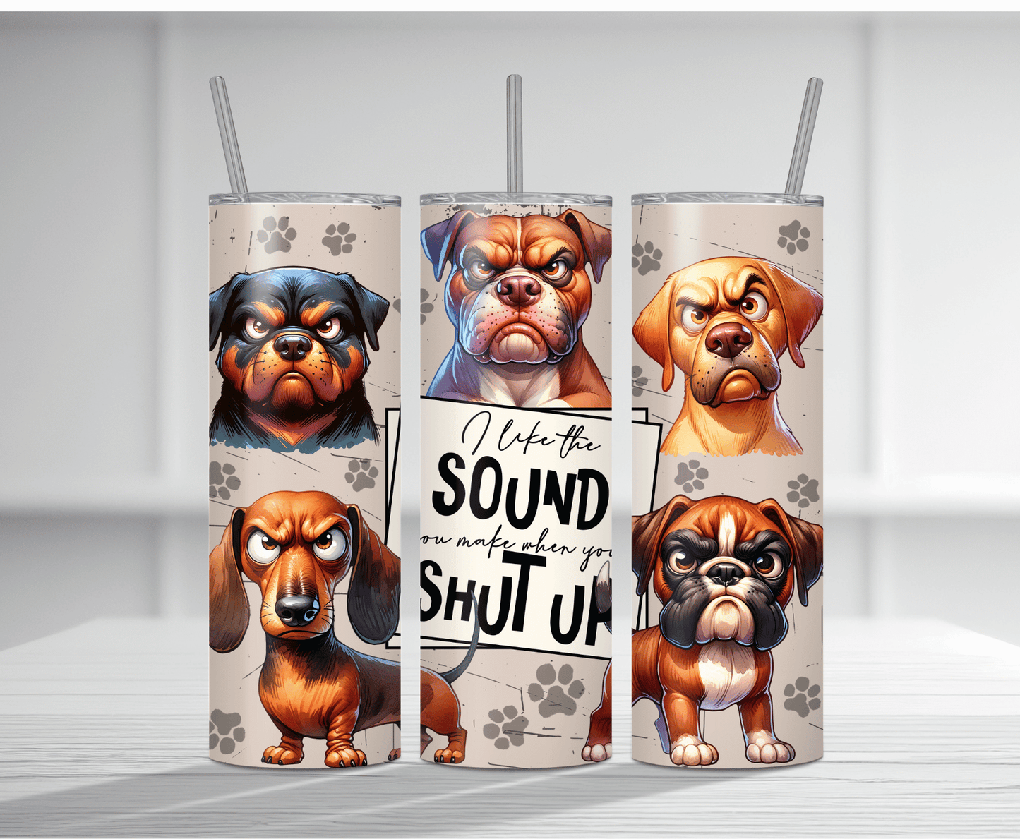 Humorous 20oz tumbler sublimation wrap featuring multiple grumpy angry cartoon dogs with the bold sarcastic text "I like the SOUND you make when you SHUT UP" on a beige paw print background.