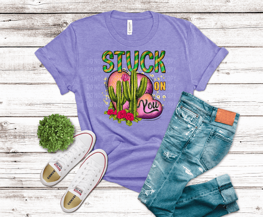 Colorful cactus and heart graphic with “Stuck On You” text, green cacti with pink hearts and roses, playful Valentine DTF transfer design.