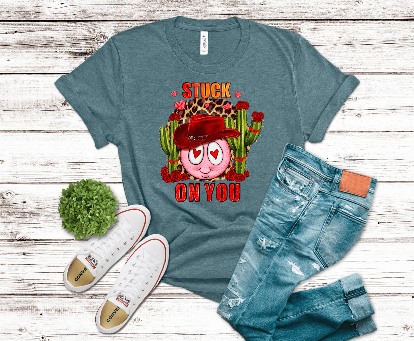 Stuck On You western Valentine DTF transfer with heart-eyed smiley, red cowboy hat, green cacti, roses, and leopard print accents.