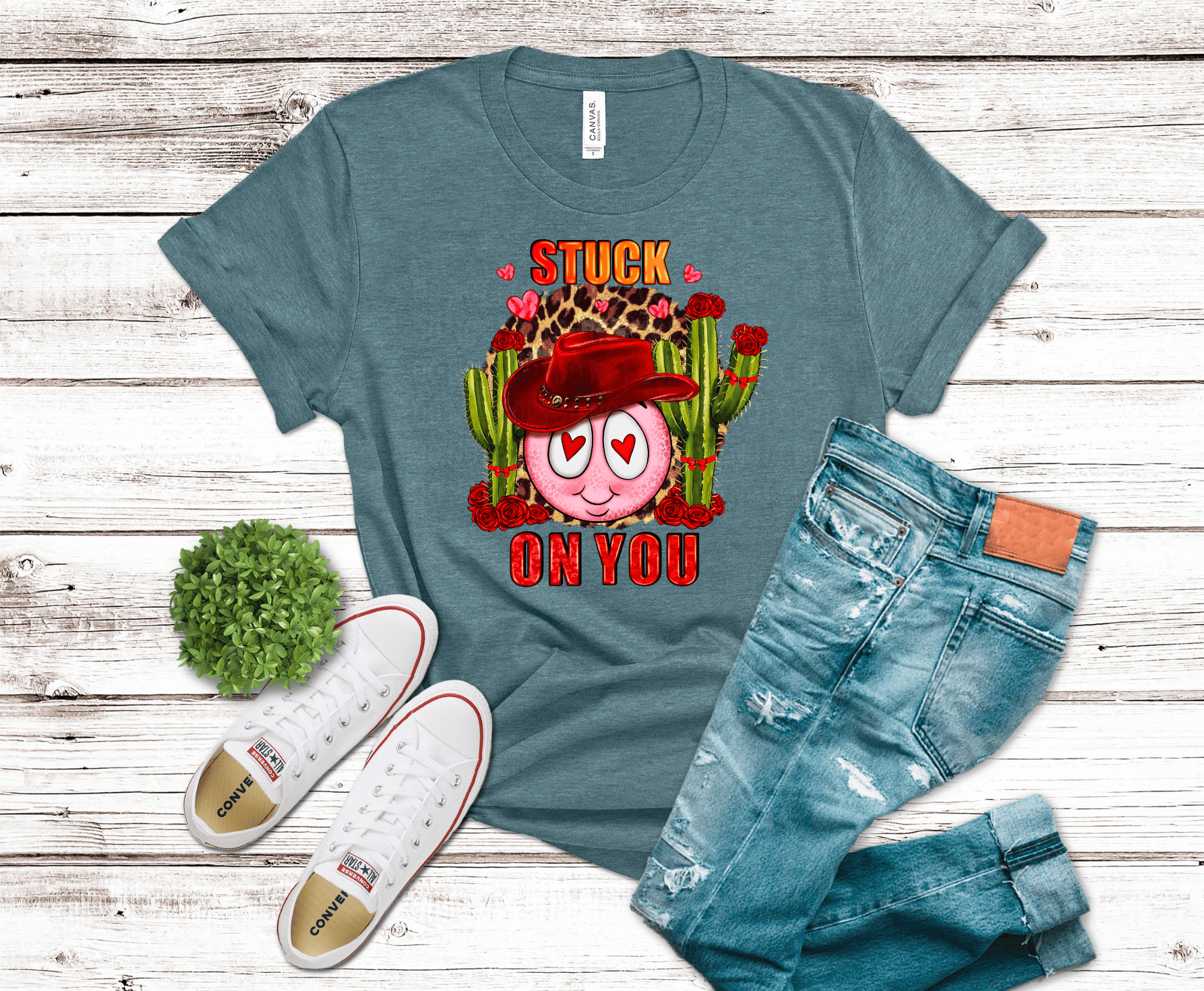 Stuck On You western Valentine DTF transfer with heart-eyed smiley, red cowboy hat, green cacti, roses, and leopard print accents.